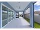 Screened-in patio with a fan and view of backyard and neighborhood at 6949 Minchew Cir, The Villages, FL 34762