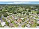 A comprehensive view from above of a friendly neighborhood with stylish homes, lush greenery, and convenient street access at 703 Royal Palm Ave, Lady Lake, FL 32159