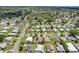 A bird's-eye view of a charming neighborhood with well-maintained homes, verdant lawns, and tree-lined streets at 703 Royal Palm Ave, Lady Lake, FL 32159