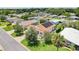 Scenic aerial view of home with solar panels surrounded by lush greenery at 703 Royal Palm Ave, Lady Lake, FL 32159