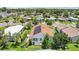 Scenic aerial view of home with solar panels surrounded by lush greenery at 703 Royal Palm Ave, Lady Lake, FL 32159