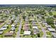 Overhead shot showcasing a peaceful neighborhood with tidy homes, green spaces, and winding streets surrounded by trees at 703 Royal Palm Ave, Lady Lake, FL 32159
