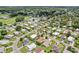 An aerial view capturing a picturesque community with tidy properties, manicured gardens, and winding roadways at 703 Royal Palm Ave, Lady Lake, FL 32159