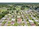 An elevated perspective showcasing a tranquil residential setting with attractive houses, vibrant lawns, and mature trees at 703 Royal Palm Ave, Lady Lake, FL 32159