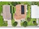 Scenic aerial view of home with solar panels surrounded by lush greenery at 703 Royal Palm Ave, Lady Lake, FL 32159