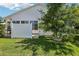 Private backyard with fence, small tree, and sunroom addition to the home at 703 Royal Palm Ave, Lady Lake, FL 32159