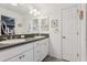 Clean bathroom showcasing a double sink, a large mirror, and vanity with ample storage space at 703 Royal Palm Ave, Lady Lake, FL 32159