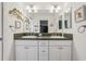 Bright bathroom showcasing double sinks, a large mirror, and ample cabinet space at 703 Royal Palm Ave, Lady Lake, FL 32159