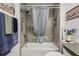 Clean bathroom showcasing a tiled shower with curtain at 703 Royal Palm Ave, Lady Lake, FL 32159