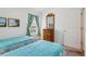 Bedroom featuring two twin beds, dresser, and natural light at 703 Royal Palm Ave, Lady Lake, FL 32159
