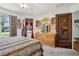 Bedroom showcasing animal print bedding, dresser, and artistically carved door at 703 Royal Palm Ave, Lady Lake, FL 32159