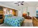 Spacious bedroom featuring natural light and a ceiling fan that ensures a comfortable ambience at 703 Royal Palm Ave, Lady Lake, FL 32159