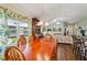Open dining area with wood table and view into the spacious living area at 703 Royal Palm Ave, Lady Lake, FL 32159