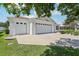 Spacious home featuring a three-car garage and well-maintained landscaping at 703 Royal Palm Ave, Lady Lake, FL 32159