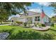 Charming home featuring a well-manicured lawn and beautiful landscaping at 703 Royal Palm Ave, Lady Lake, FL 32159