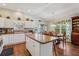 Bright kitchen with white cabinets and an island flowing into the dining area at 703 Royal Palm Ave, Lady Lake, FL 32159