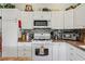 Well-equipped kitchen with modern appliances, white cabinets, and stylish backsplash at 703 Royal Palm Ave, Lady Lake, FL 32159