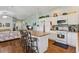Kitchen boasts a center island with seating, complemented by modern appliances and white cabinetry at 703 Royal Palm Ave, Lady Lake, FL 32159