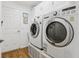 Laundry room showcasing stacked washer and dryer with cabinets for storage at 703 Royal Palm Ave, Lady Lake, FL 32159