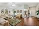 Spacious living room with vaulted ceiling, wood floors, and access to the front entry at 703 Royal Palm Ave, Lady Lake, FL 32159