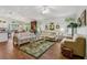 Cozy living room with hardwood floors, ceiling fan, and bright, natural light at 703 Royal Palm Ave, Lady Lake, FL 32159