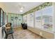 Enclosed sunroom with a ceiling fan and large windows, perfect for home office at 703 Royal Palm Ave, Lady Lake, FL 32159