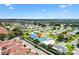 Charming residence with a blue roof nestled in a meticulously maintained neighborhood with tree-lined streets and vibrant landscaping at 714 Prado Dr, The Villages, FL 32159
