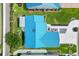 Birds eye view of home, bright blue roof, and lush green landscaping at 714 Prado Dr, The Villages, FL 32159