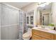 Well-lit bathroom with a shower and a wooden vanity at 714 Prado Dr, The Villages, FL 32159