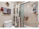 Clean bathroom showcasing updated shower with glass door and a floral-themed shower curtain at 714 Prado Dr, The Villages, FL 32159