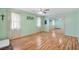 Bedroom featuring pale green walls, hardwood floors, a ceiling fan, and a mirrored closet at 714 Prado Dr, The Villages, FL 32159