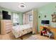 Cozy bedroom showcasing a pull-down bed, ample storage, a TV, and a desk at 714 Prado Dr, The Villages, FL 32159