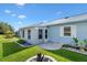 Back exterior with new windows and landscaping at 714 Prado Dr, The Villages, FL 32159