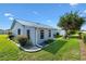 Exterior view of home with new windows, landscaping, and a green lawn at 714 Prado Dr, The Villages, FL 32159