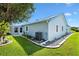Light-blue exterior showcasing well-maintained landscaping and a modern air conditioner at 714 Prado Dr, The Villages, FL 32159