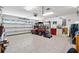Spacious garage with a golf cart, tools, and ample storage at 714 Prado Dr, The Villages, FL 32159