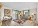 Bright living room with neutral paint, plush seating, and sliding doors to outdoor area at 714 Prado Dr, The Villages, FL 32159