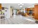 Spacious living area with tile flooring, kitchen island, and open flow to the living room at 714 Prado Dr, The Villages, FL 32159