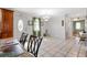 Inviting living area with tile flooring, a dining space, and views of the front entrance at 714 Prado Dr, The Villages, FL 32159