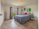 Bright bedroom featuring a large window, tile flooring, and stylish decor at 7211 Se 120Th St, Belleview, FL 34420