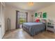 Bright bedroom featuring a large window, tile flooring, and stylish decor at 7211 Se 120Th St, Belleview, FL 34420