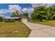 Home featuring an attached garage and a long driveway leading to a charming single-story residence at 7211 Se 120Th St, Belleview, FL 34420