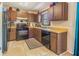 Charming kitchen featuring wood cabinets, tile flooring, and modern appliances at 7211 Se 120Th St, Belleview, FL 34420