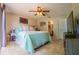 Spacious main bedroom with tile flooring, ceiling fan and sliding glass door to lanai at 7211 Se 120Th St, Belleview, FL 34420