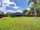 Expansive backyard with a screened-in pool, lush lawn, and mature trees, ideal for outdoor living at 728 Silversmith Cir, Lake Mary, FL 32746