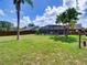 Lush backyard featuring a screened-in pool, mature palms, and ample space for relaxation and entertainment at 728 Silversmith Cir, Lake Mary, FL 32746