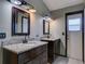 Bathroom featuring dual sinks, granite countertops, and modern fixtures at 728 Silversmith Cir, Lake Mary, FL 32746