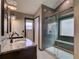 Modern bathroom featuring dual sinks, granite countertops, and a spacious walk-in shower with a bench at 728 Silversmith Cir, Lake Mary, FL 32746