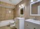 Bathroom with tiled shower over tub, and dual sinks with white cabinets at 728 Silversmith Cir, Lake Mary, FL 32746