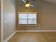 Bright bedroom features wood-look flooring, a ceiling fan, and a large window for ample natural light at 728 Silversmith Cir, Lake Mary, FL 32746